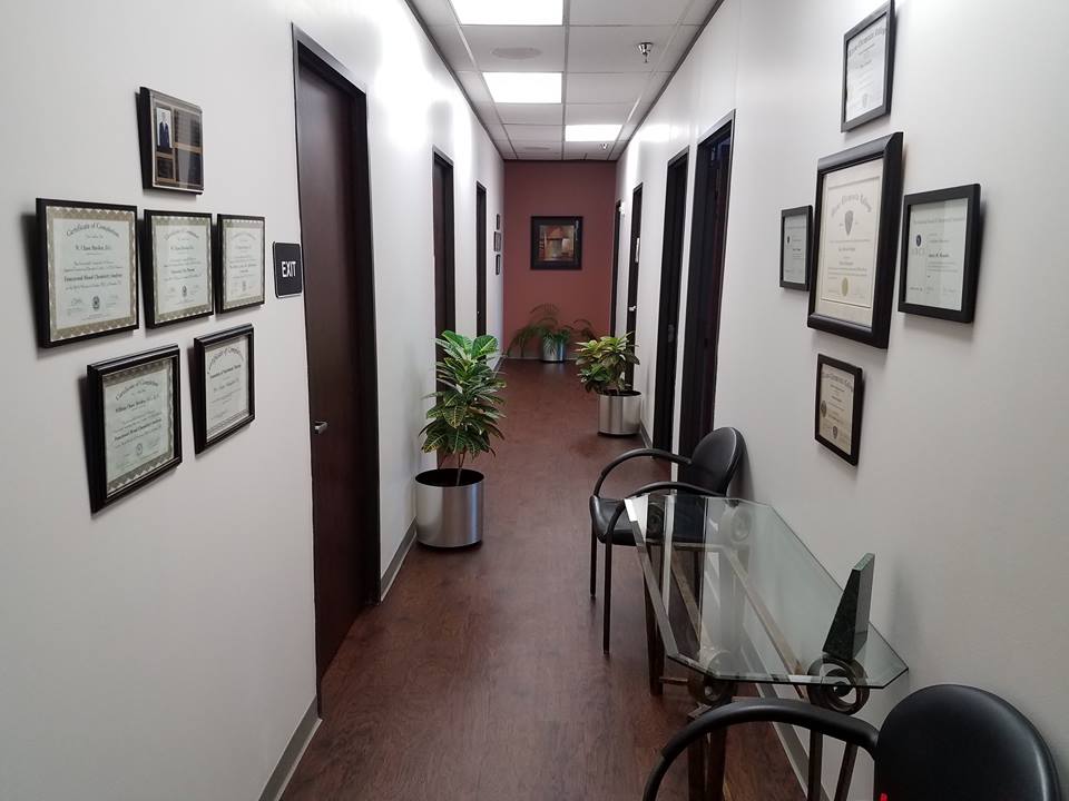 From the entry, the main hallway leads to the various treatment rooms, including Pam's massage room, the rehabilitation room, and two treatment rooms.